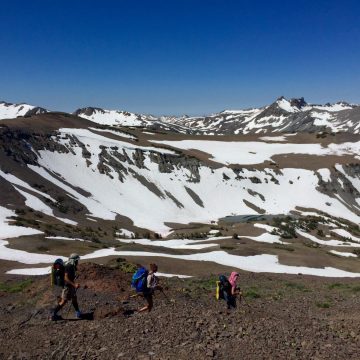 Beardoh Sweet Pea and Gazelle hiking above snow filled basins