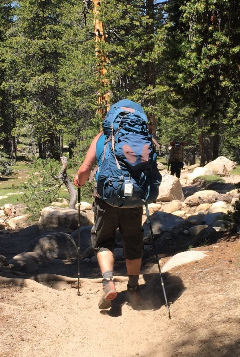 A weekend hiker on the PCT with a giant backpack towering over their head