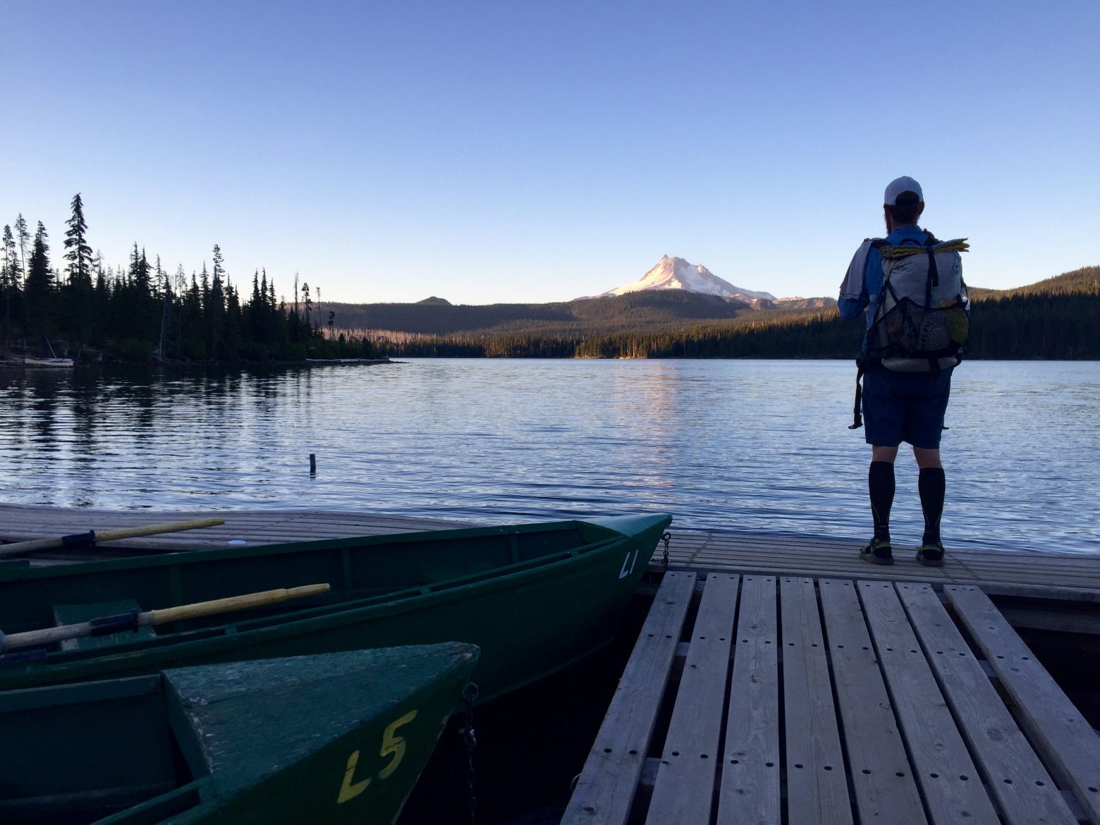 Mountain Man looking at Mt. Jefferson from the dock at Olallie Lake
