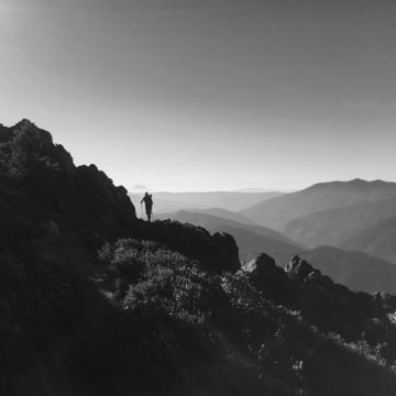 A silhouette of Sweet Pea hiking the trail