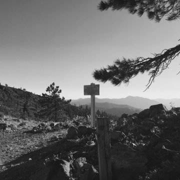 Late day shadows cast by a PCT trail sign on a ridge