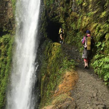 Beardoh and Sweet Pea crossing behind Tunnel Falls on the Eagle Creek trail
