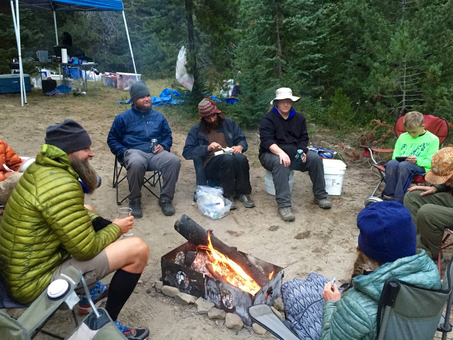 PCT thru-hikers gathering around a fire at trail magic