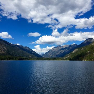 Blue sky and puffy white clouds above the North Cascades and Lake Chelan