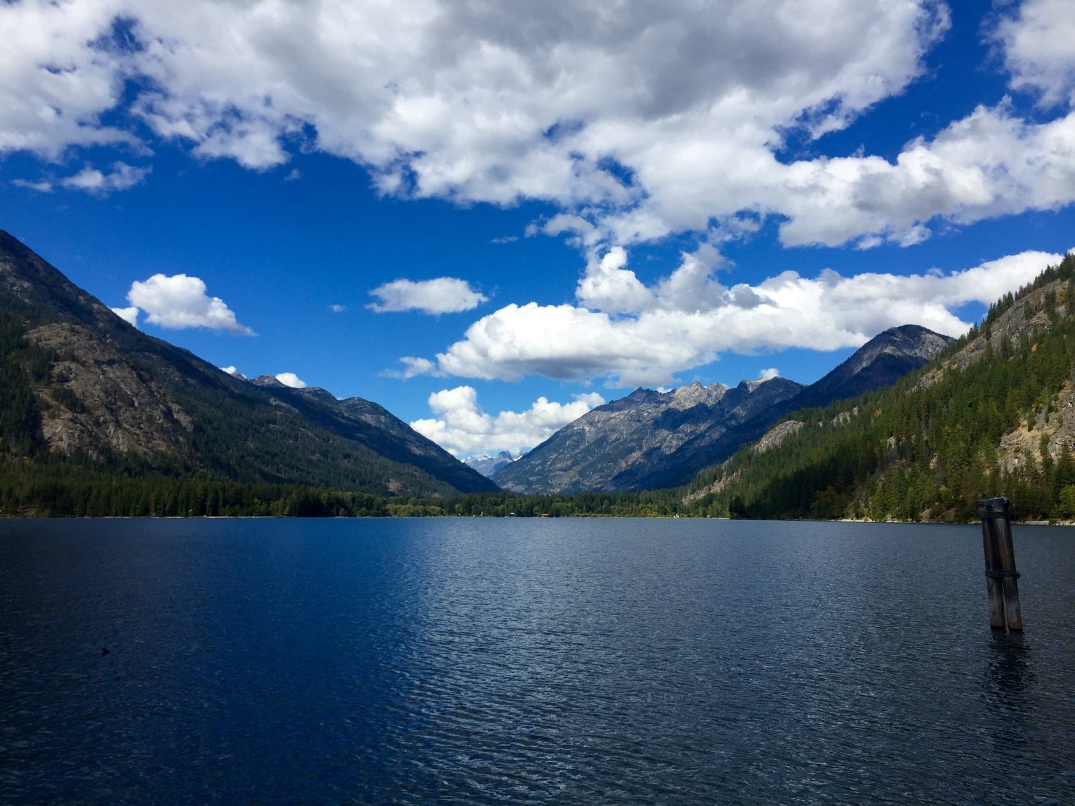 Blue sky and puffy white clouds above the North Cascades and Lake Chelan