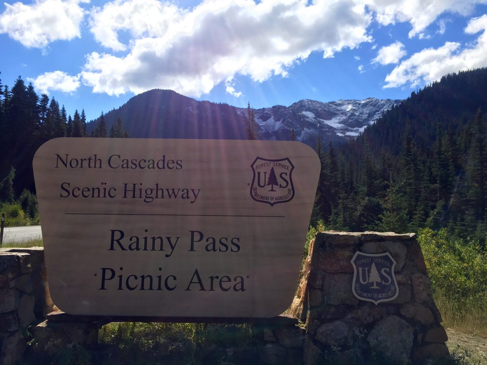 Rainy Pass sign under blue skies