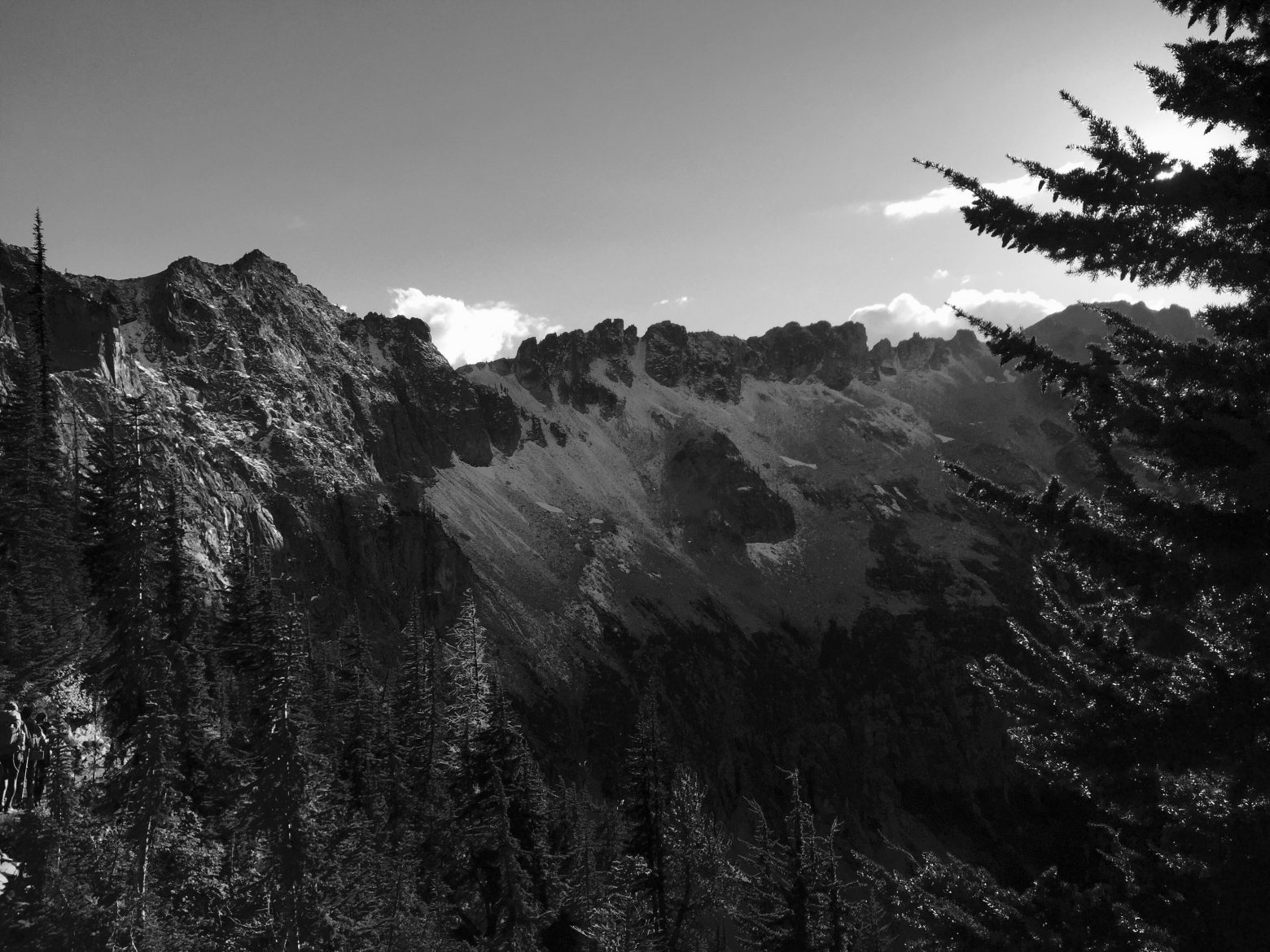 Black and white ridge with dusting of snow extending from Granite Pass