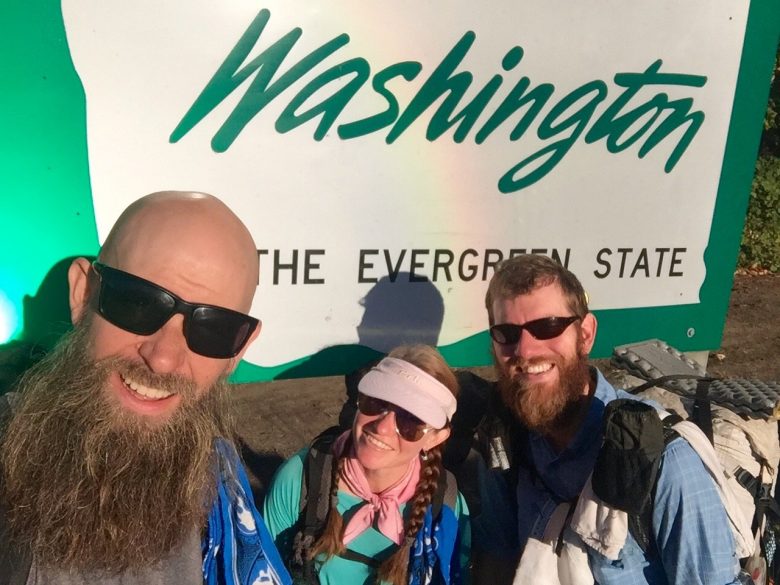 Beardoh Sweet Pea and Mountain Man in front of Welcome to Washington State sign