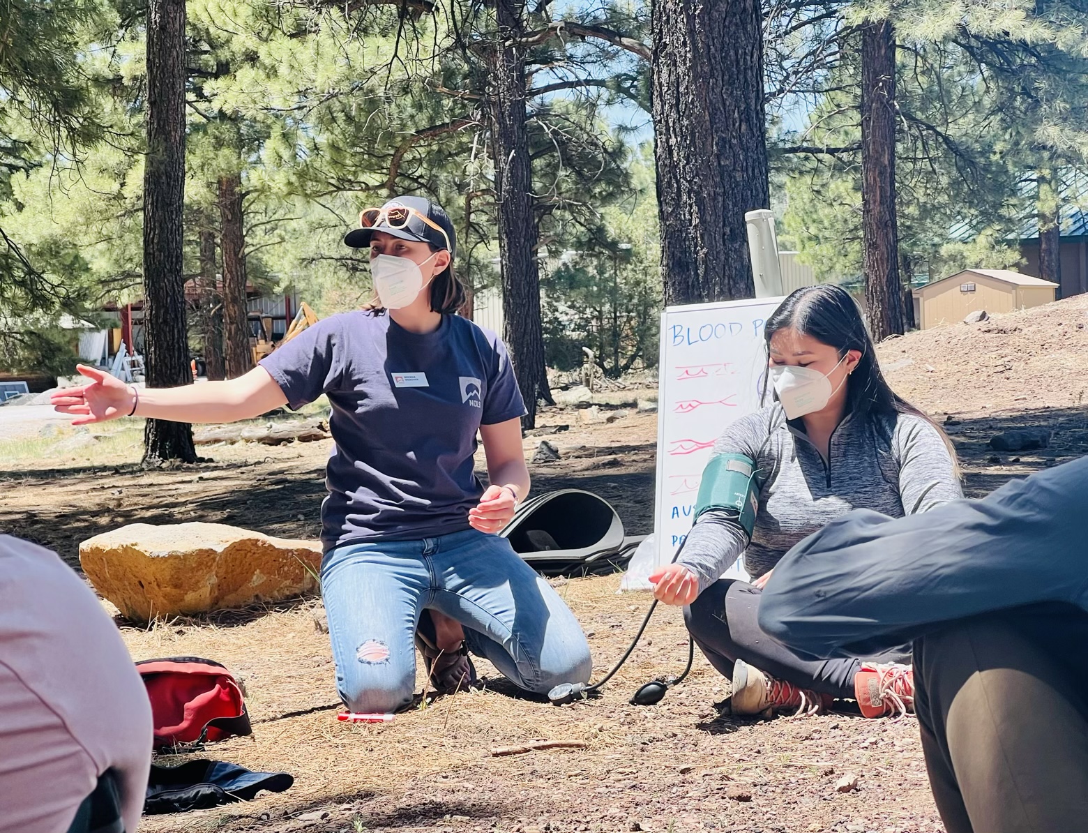 Brenna teaching the basics of blood pressure at a hybrid Wilderness First Responder course