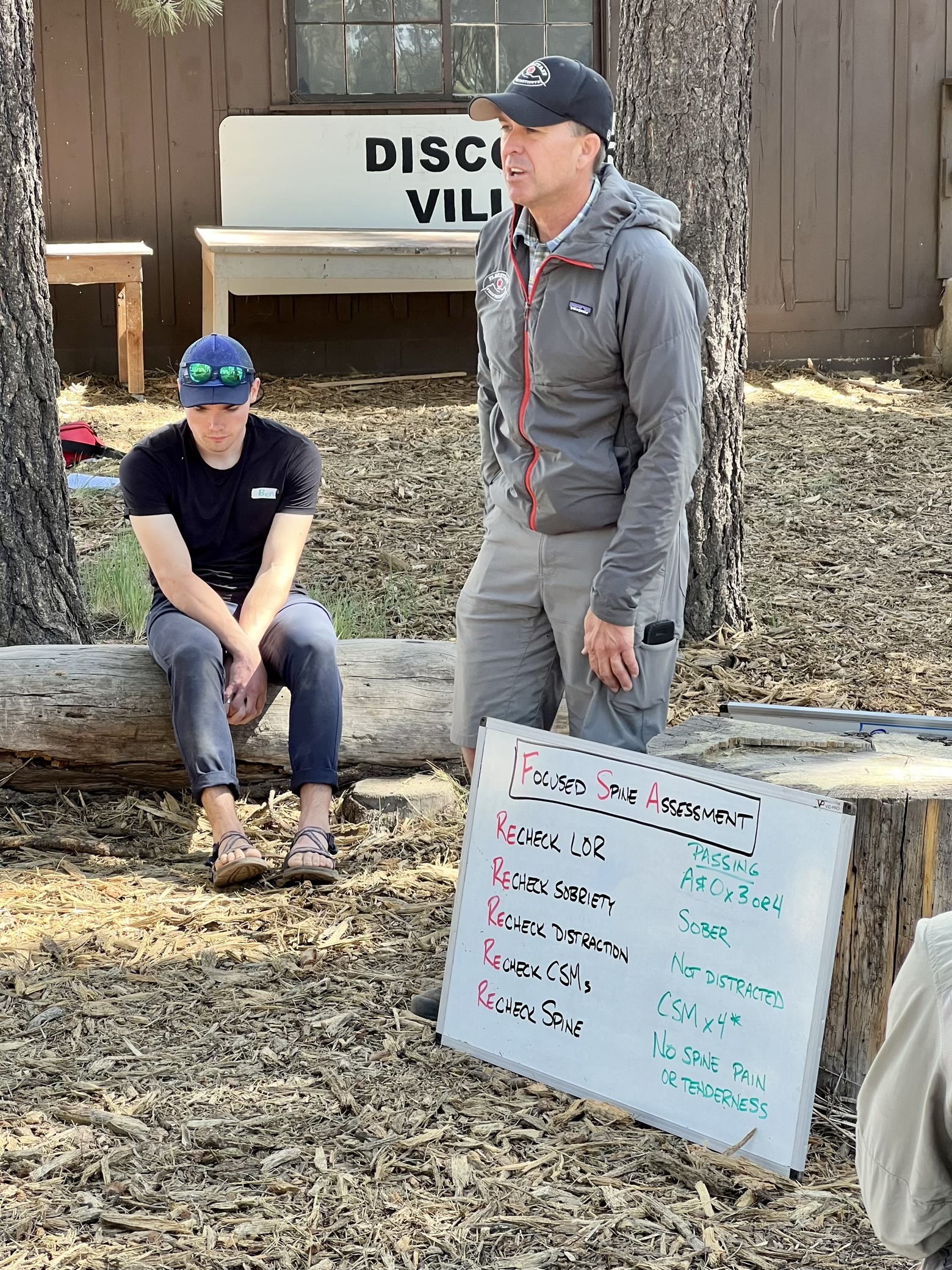 Pete of the Flagstaff Field Institute detailing the Focused Spine Assessment at a hybrid Wilderness First Responder course