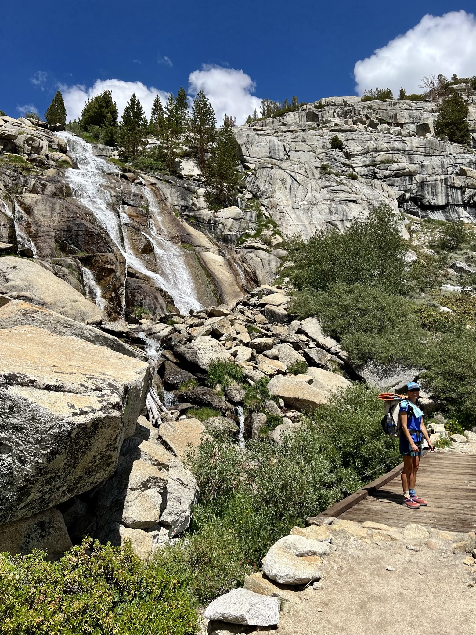 Ace beside a waterfall on the descent back to the JMT