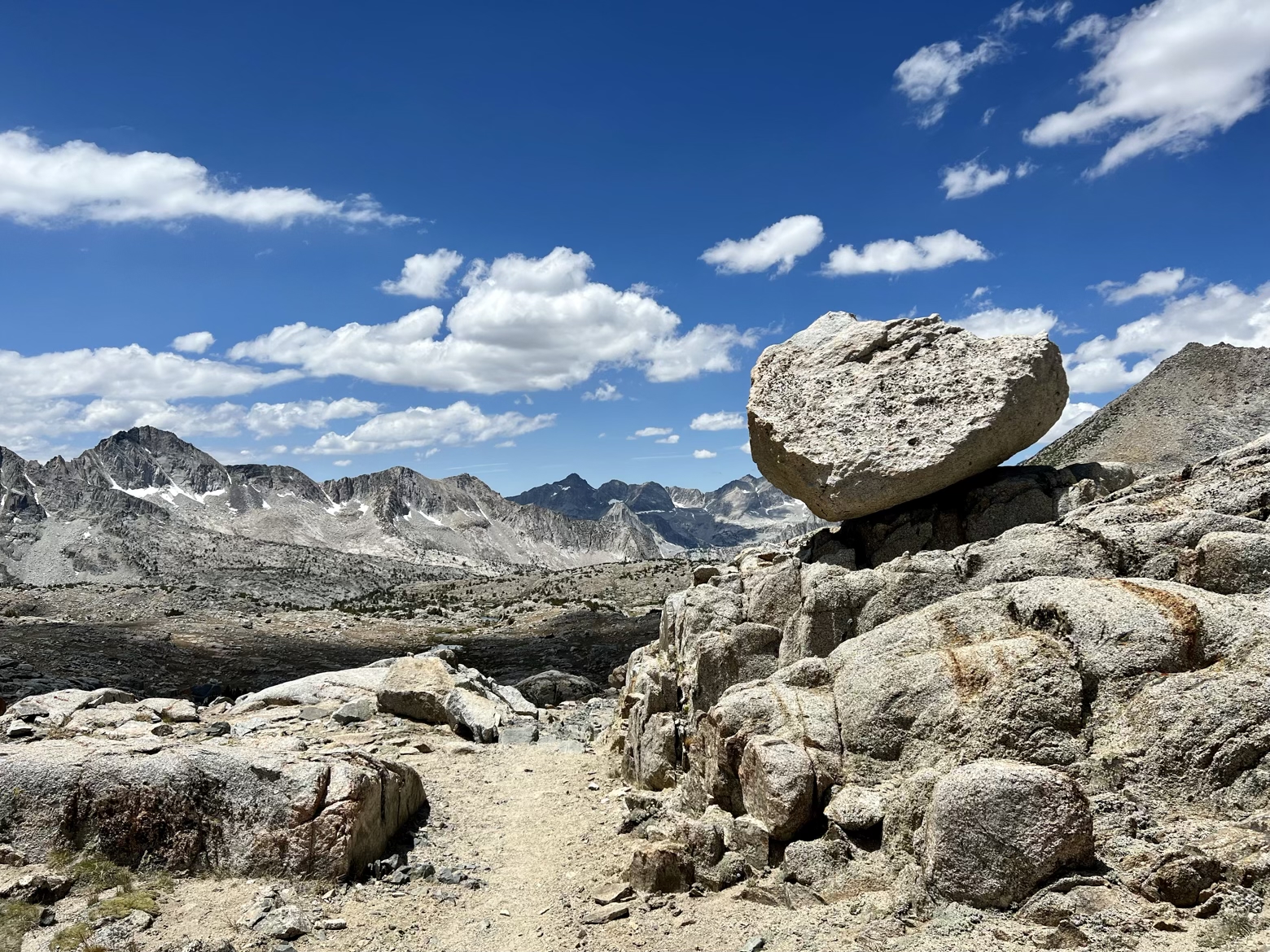 Teetering boulder beneath a blue sky in Dusy Basin